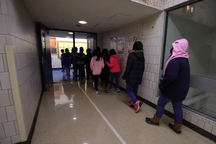 Students walk to their classroom at Yung Wing School P.S. 124 in Manhattan.